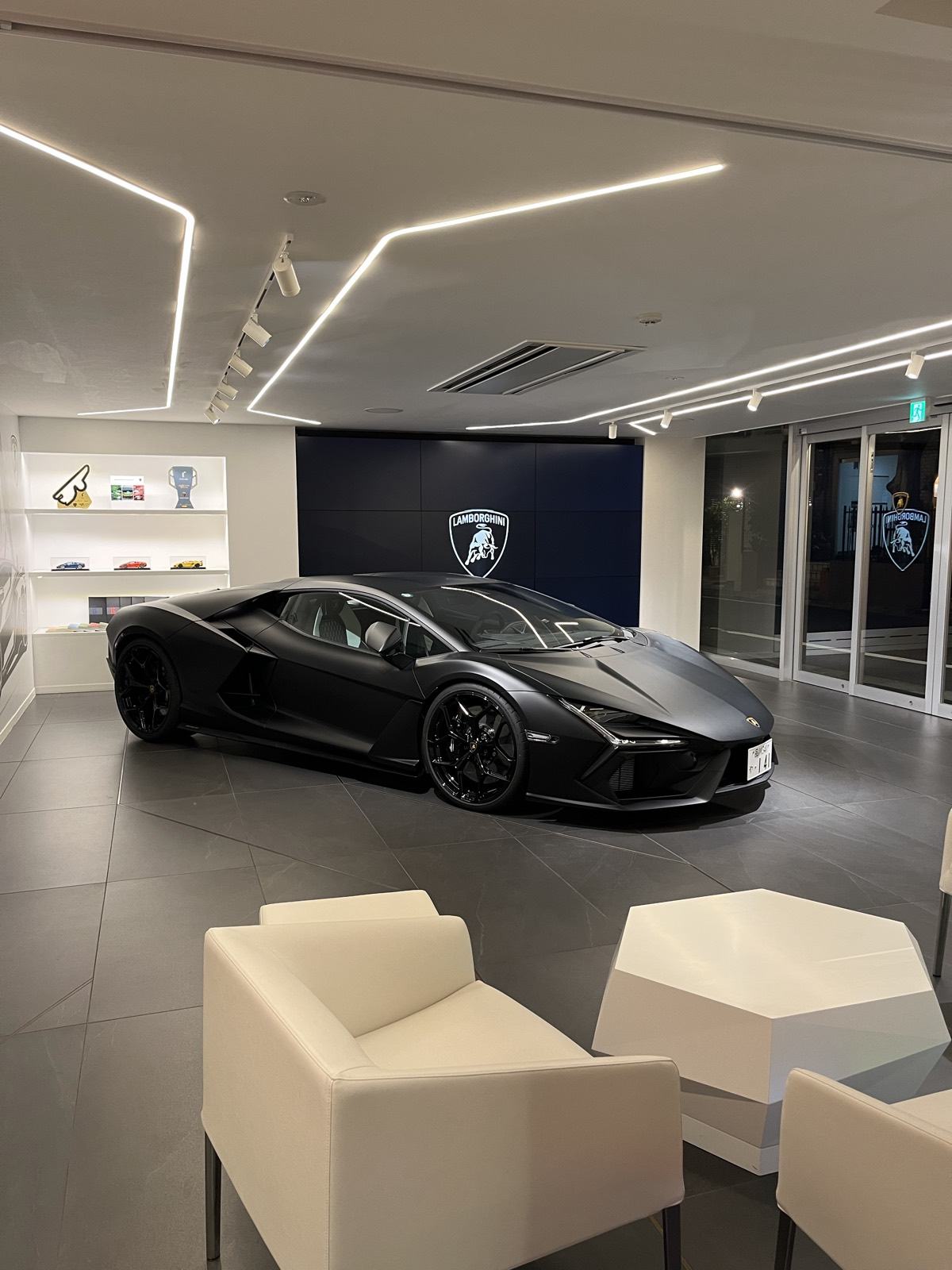 Matte black Lamborghini Revuelto, the hybrid V12 used by TOKYO SUPERCAR DRIVE, photographed indoors on delivery day